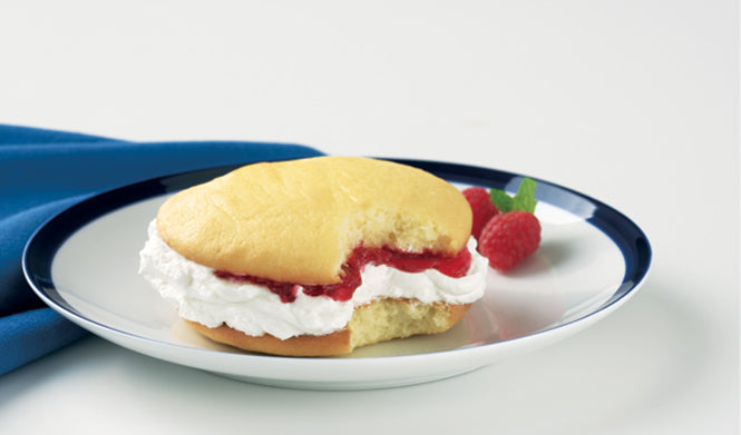 Yellow cake shells with light and fluffy homemade vanilla filling and a surprise of raspberry preserves in the middle of each one.